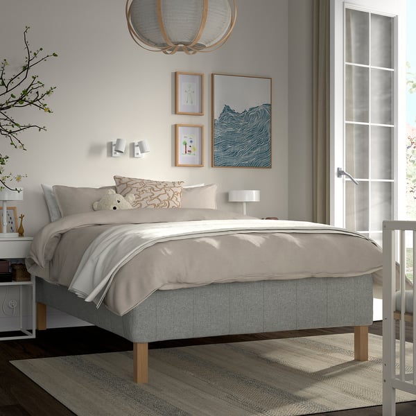 Minimalist bedroom with RISHÖJDEN bed, grey frame, and map pillow. Large window, nightstand, and natural light.