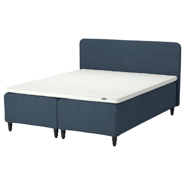 Blue bed with white mattress, upholstered headboard, wooden legs.