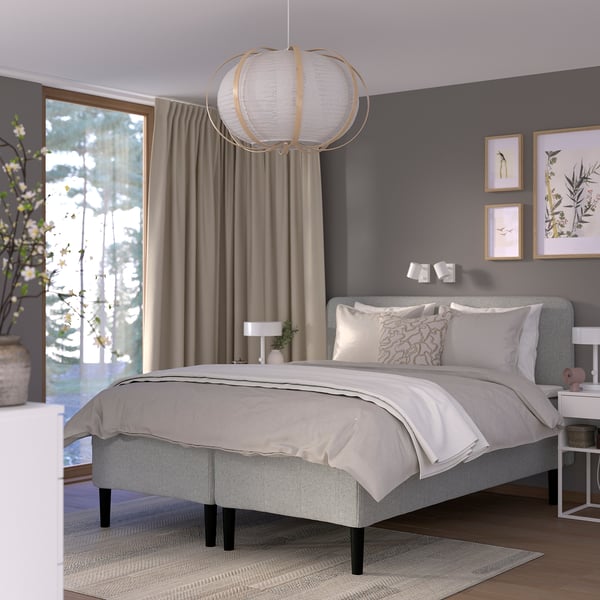 Modern bedroom with RISHÖJDEN bed, grey bedding, large window, hanging light, nature prints.