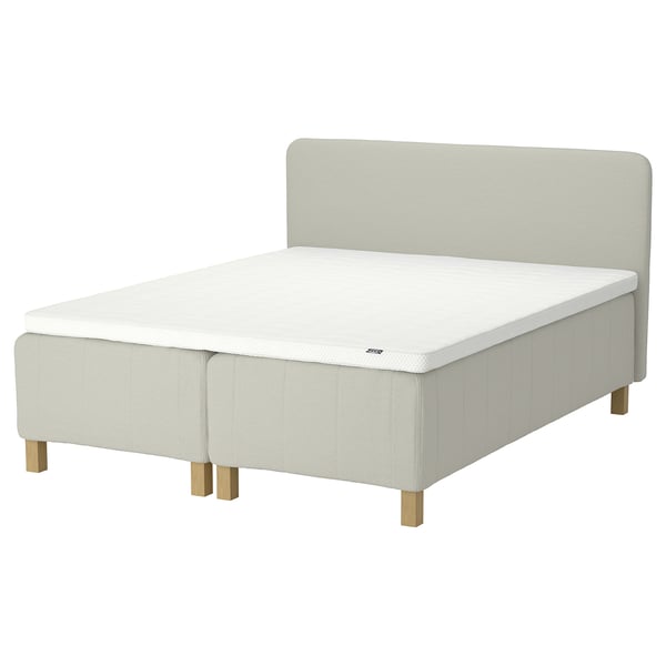 Minimalist bed with padded headboard, light beige, upholstered fabric, rectangular shape, and wooden legs.