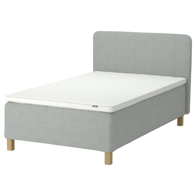 A light grey RISHÖJDEN upholstered bed with a white mattress and wooden legs.