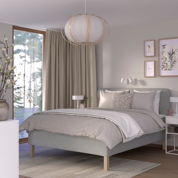 Modern bedroom with RISHÖJDEN grey bed, floral decor, and large window.