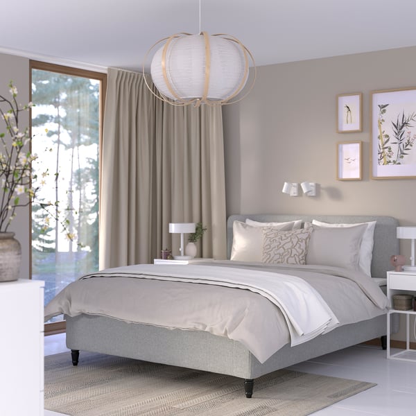 Modern bedroom with RISHÖJDEN bed, pocket springs, neutral tones, gray bedding, white walls, large windows, hanging lamp, framed art, and nightstands.