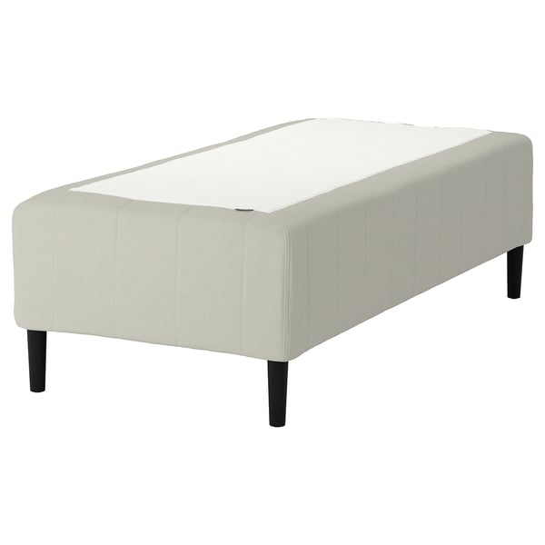 The RISHÖJDEN mattress base 7 comfort zones for spine alignment, tufted design, light beige color, and sturdy wooden legs for support.