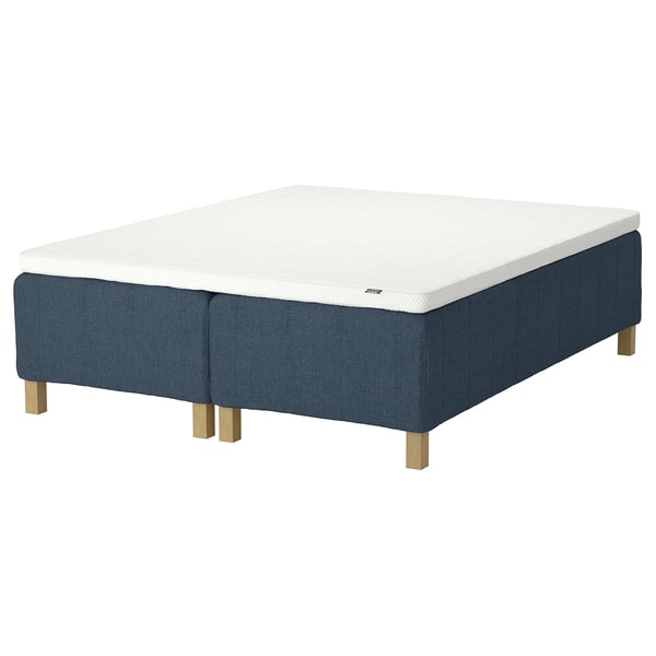 IKEA RISHÖJDEN bed base in blue fabric with wooden legs, white mattress.