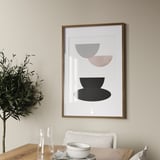 Modern dining room with framed abstract art and wooden table set for tea.
