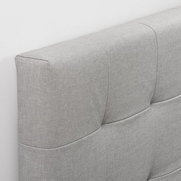 Soft, upholstered headboard with neat stitching, mounted on wall. Offers cozy comfort for reading or watching tv in bed.