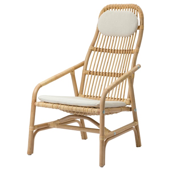 SALNÖ natural rattan armchair with white cushions, woven design, curved back, and armrests.