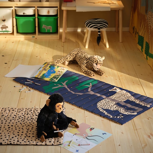 Blue savannah play mat with monkey and zebra toys, kid-friendly.