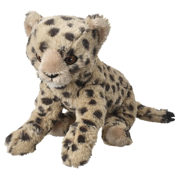 Stuffed snow leopard toy with beige and dark spots, sitting, soft white background.