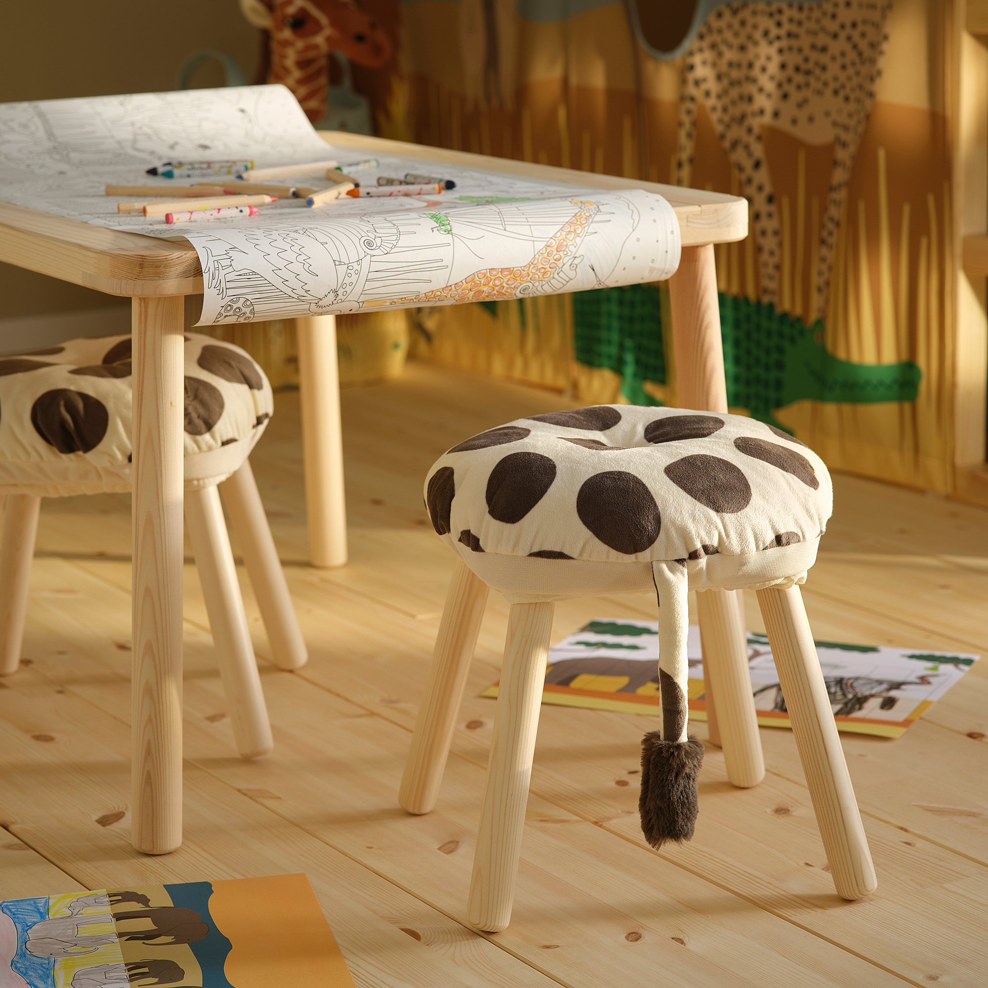 Childs room with giraffe stools, coloring table, toys; playful & inviting.
