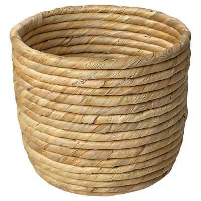 A SANDÖDLA plant pot, round and woven from natural sedge and water hyacinth. The pots rustic texture adds warmth, making it ideal for indoor plants.