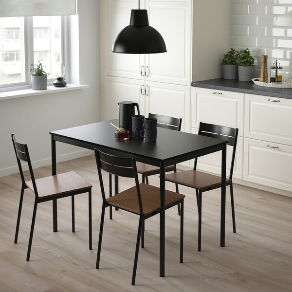 Modern black sandberg dining set with sleek table and minimalist chairs, perfect for small spaces.