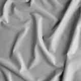 A close-up of luxurious, creased velvet curtains, revealing their soft, plush texture and elegant drape.