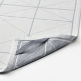 Folded white geometric-patterned cloth, showing high-quality fabric blend, neatly stitched edges.
