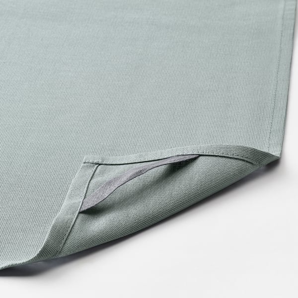 A close-up of soft, light blue fabric, neatly stitched.