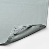 A close-up of soft, light blue fabric, neatly stitched.