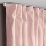 Light pink curtains hang neatly, showing pleated velvet texture. Rogue hooks secure top edges for elegant folds.