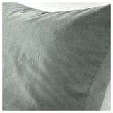 Soft grey-green cotton velvet cushion, close-up, displaying luxurious texture.