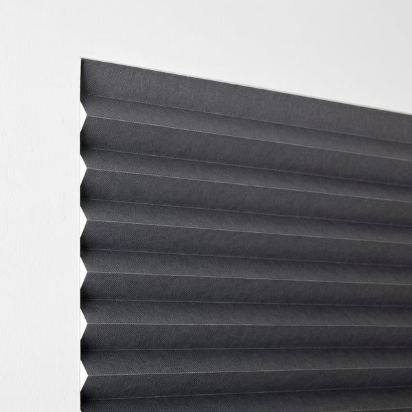 Pleated blackout blind, attaches without drilling, darkens room, holds open with clips.