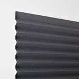 Pleated blackout blind, attaches without drilling, darkens room, holds open with clips.