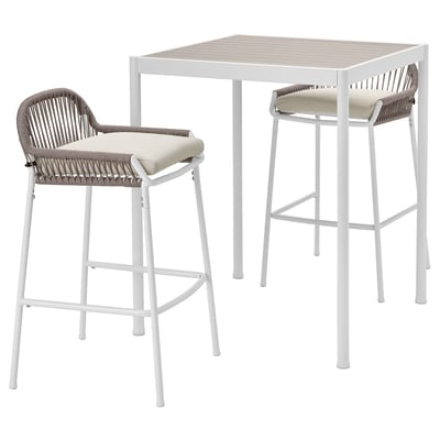White patio set with wicker chairs and table.