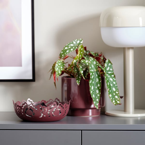 Modern home decor: maroon bowl & planter, retro lamp.