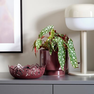 Modern home decor: maroon bowl & planter, retro lamp.