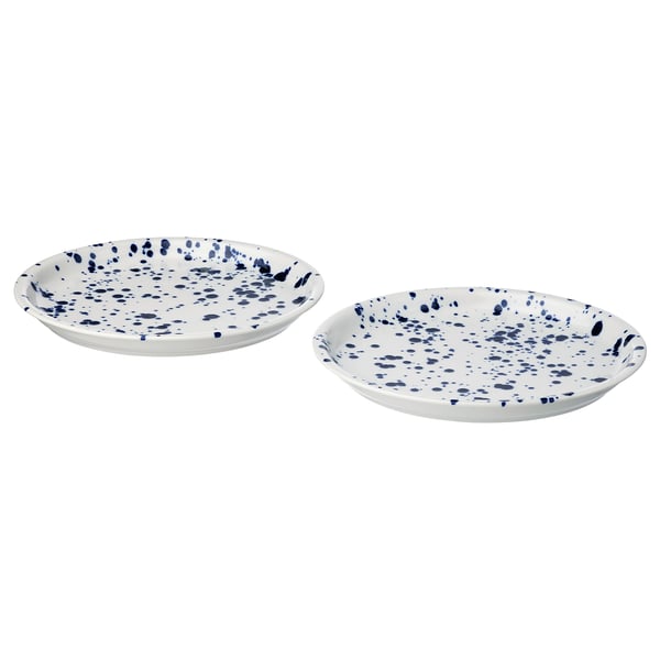 Two round, white plates with blue splatter pattern, made of stoneware, placed side by side.