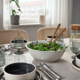 A table set with SILVERSIDA tableware, featuring a salad bowl, glasses, and cutlery.