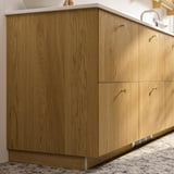 Wooden kitchen cabinet in warm oak with minimalist design.