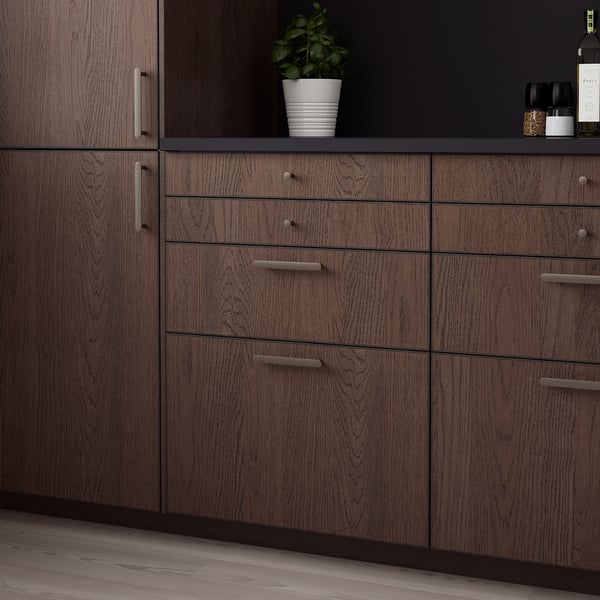 Dark wood SINARP cabinet with sleek handles, featuring solid oak edges. Size: large, fits against tall units.
