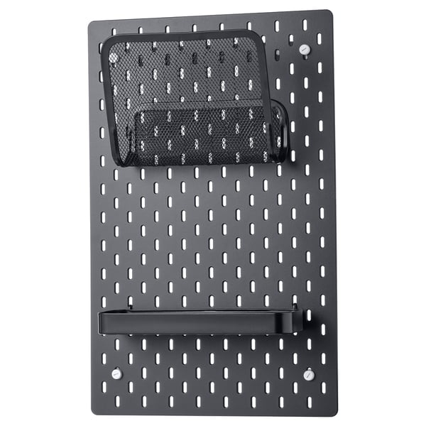 A black SKÅDIS pegboard with mesh pouch and shelf. It is designed for wall organization.