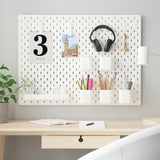 SKÅDIS pegboard organizer in white, sizeable for workspace, holds various items neatly.