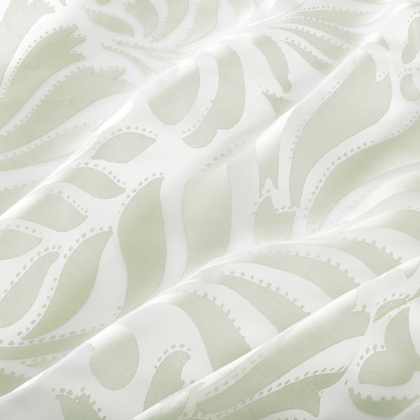 Floral sheer curtains with soft, flowing fabric, allowing light through while offering privacy.