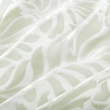Floral sheer curtains with soft, flowing fabric, allowing light through while offering privacy.