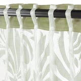 Sheer green-white curtains hang, allowing light through, with visible rod and hanging tabs.
