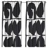 Black and white leaf-patterned curtains with black edging.