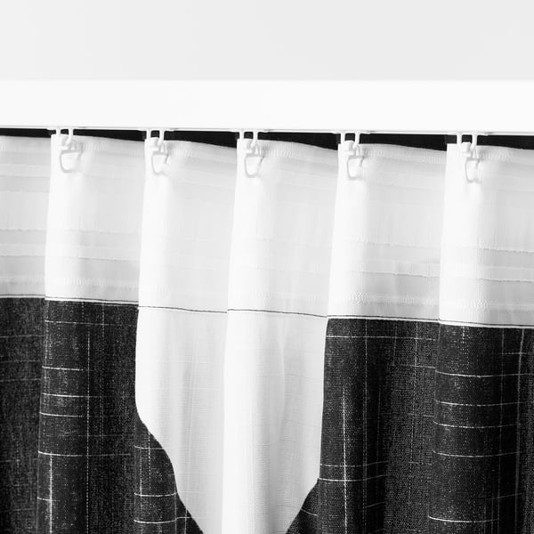 Black and white patterned curtains with hooks and tabs, designed for privacy and light control.