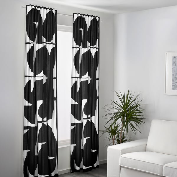 Black & white curtains by window, tall, diffused light, privacy.