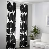 Black & white curtains by window, tall, diffused light, privacy.
