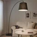 Modern living room with SKAFTET lamp, sofa, and coffee table.