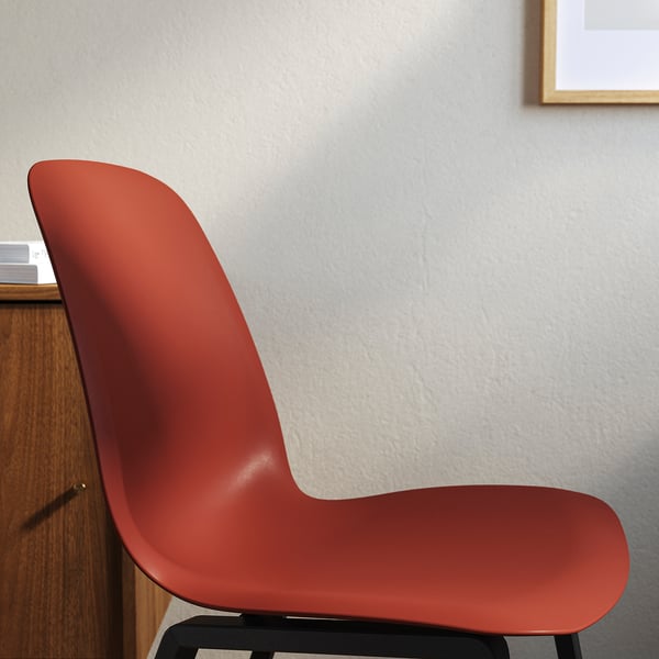 Red modern chair against gray wall