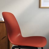 Red modern chair against gray wall