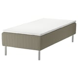 A skarer bed with a white mattress and grey upholstered base on stainless steel legs.