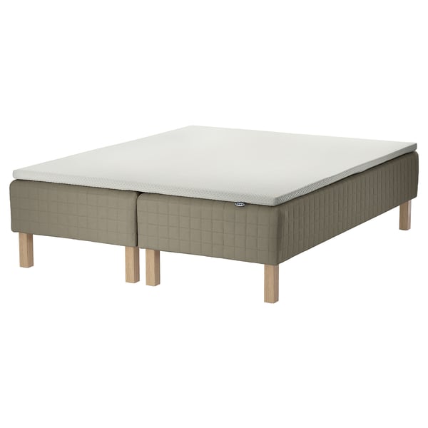 The SKÅRER wooden-base sprung mattress in beige with legs. It is square-shaped and covered in quilted fabric.