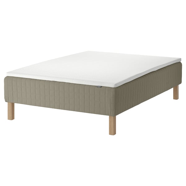 The SKÅRER bed base in beige with a white mattress. Its a wooden bed base with a simple, rectangular shape and light gray wooden legs.