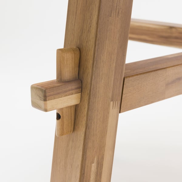 A sturdy wooden table leg joint, finely crafted with durable acacia wood, showcasing precise joinery.