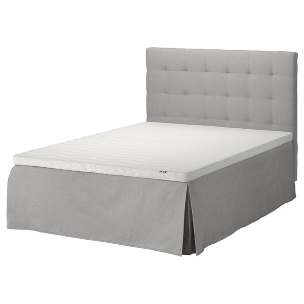 A grey SKOTTERUD bed with a padded headboard and a white mattress.