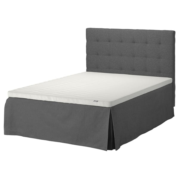 A modern gray bed with a tufted headboard and white mattress.